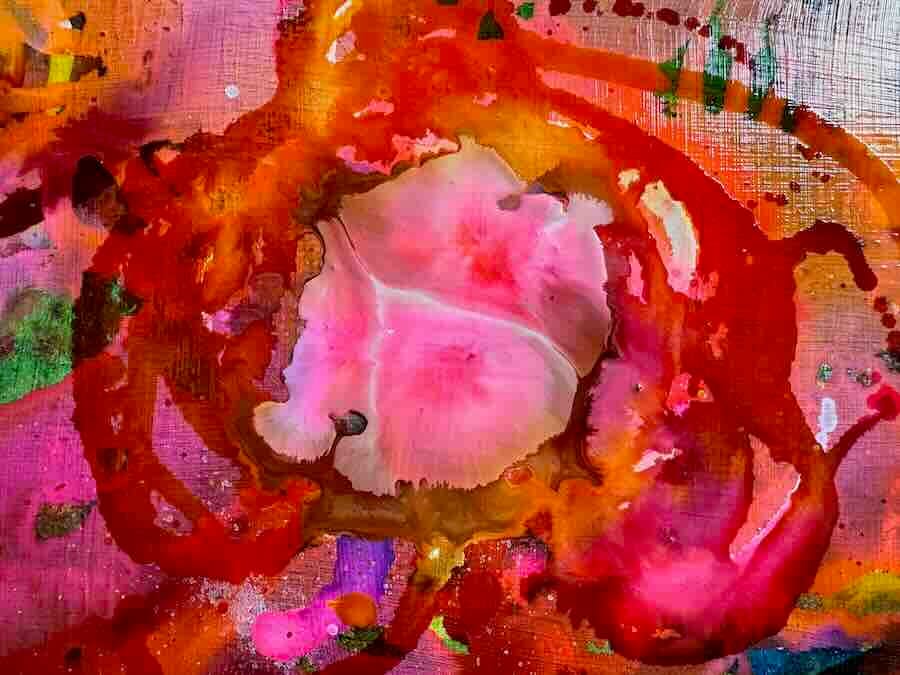 Colorful abstract painting with red and pink swirls.