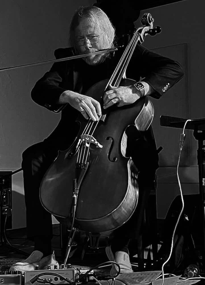 Musician playing cello on stage